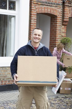 Furniture removal team collecting bulky items in a Knightsbridge apartment building