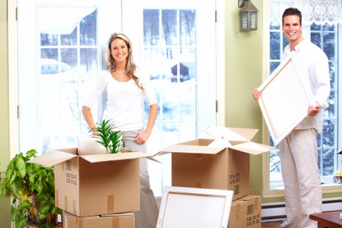 Movers loading boxed household items into a van in Knightsbridge