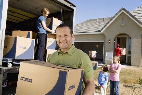 Local movers handling furniture and boxes in a Knightsbridge street
